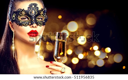 Sexy model woman with glass of champagne wearing venetian masquerade mask at party, drinking champagne over holiday glowing background. Christmas and New Year celebration, Dark blinking background