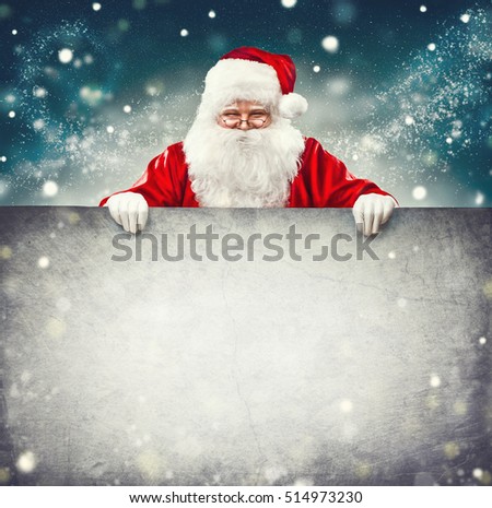 Happy Santa Claus holding blank advertisement banner background with copy space. Smiling Santa Claus pointing in white blank sign. Christmas theme, sales