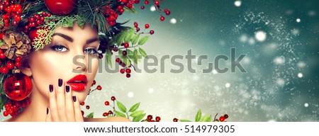 Christmas Woman Makeup. Winter Fashion Girl. Beautiful New Year and Christmas Tree Holiday Hairstyle, Make up, manicure. Beauty Model on winter Background. Creative Hair style decorated with Baubles