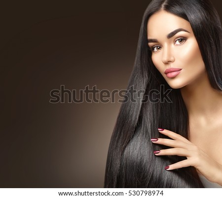 Beautiful long Hair. Beauty woman with luxurious straight black hair on dark background. Beautiful brunette Model girl touching Healthy Hair. Lady with long smooth shiny straight hair. Hairstyle, cure