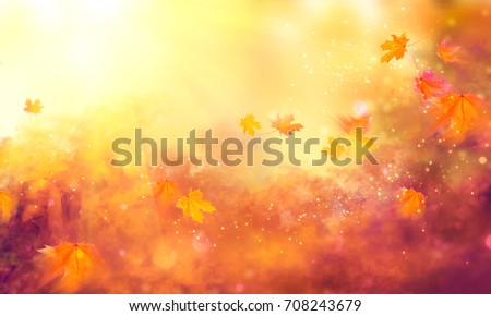 Autumn background. Fall Abstract autumnal background with colorful leaves and sun flares, flying on wind colorful bright leaves, yellow, orange and red colors backdrop. Abstract art design.