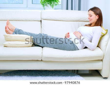 Pregnant Woman Resting on the Sofa at Home