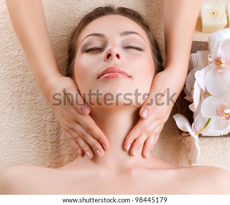 Spa Massage . Young Woman Getting Facial Massage