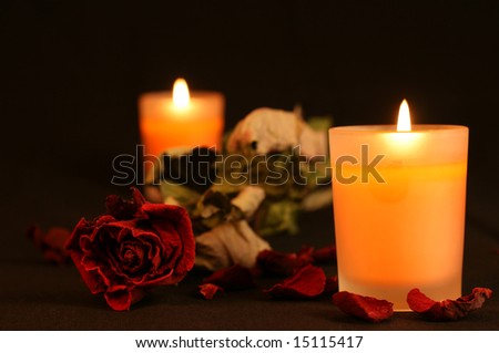 Orange candles, light and red rose