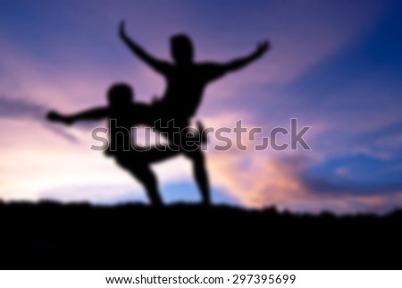 Blur Silhouette happy people jumping against beautiful in sunset. Freedom, enjoyment concept