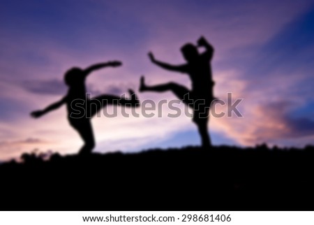 Silhouette happy people jumping against beautiful in sunset. Freedom, enjoyment concept, blur background