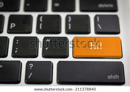 Black keyboard with word HI on the orange keyboard key