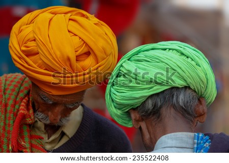 PUSHKAR,INDIA - November 3,2014 : Unidentified Indian men with their traditional turban on their hand chatting in Pushkar Mela,India.