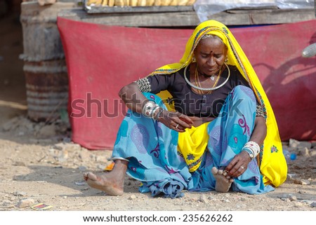 PUSHKAR,INDIA - November 3,2014 : Unidentified woman with her piercings and ornaments dress colorful and  traditional sari and scarf in Pushkar Mela,India