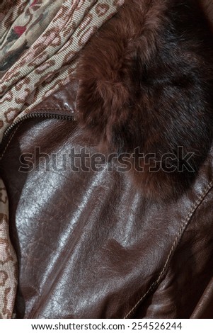 Detail of leather coat with scarf and the zipper