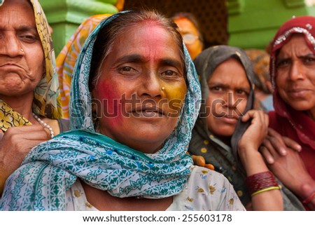 MATHURA,INDIA - March 28,2013 :Unidentified women painted  with  powder paints and water thrown by the others during the Holi celebration in Mathura.Holi festival  is one of the most colorful event