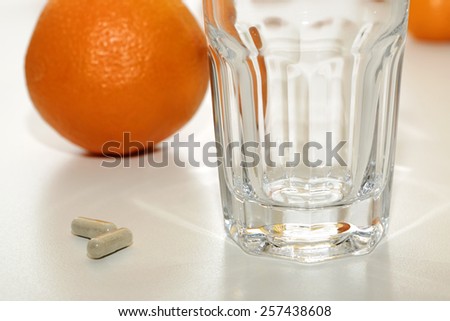 Vitamin C pills and Oranges