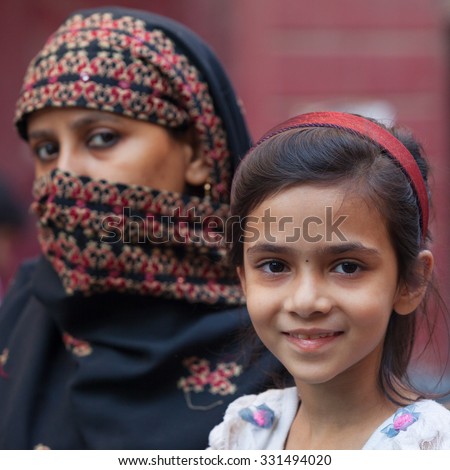 DELHI,INDIA - April 3, 2013 : Unidentified woman and her daughter on the streets of Delhi,India