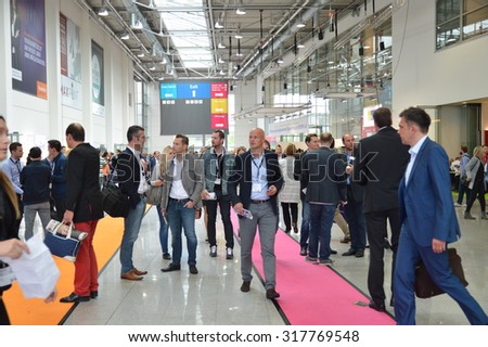 Cologne, Germany - September 16, 2015 - Young business people rushing by on digital marketing exhibition and trade show Dmexco