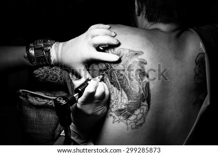 Showing process of making a tattoo, woman is tattoo artist, Tattoo design in pattern