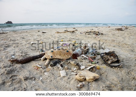 Waste on the sands causes environmental pollution. ocean beach. trash on beach