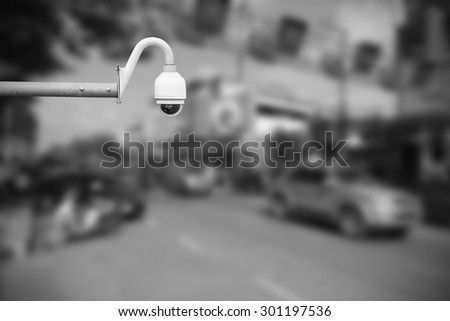 CCTV camera or surveillance operating on traffic road.Daytime