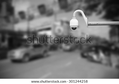 CCTV camera or surveillance operating on traffic road.Daytime. CCTV Gray tone.