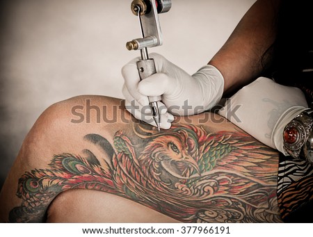 Tattoo artists are tattooing women clients black background. Decoration Art Machine Making Process Studio Man Female Lifestyle Body Action Designs Ink Master Gun Concept Skin People Free Artwork Draws
