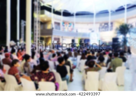 Blur concert crowd enjoying the music background. Blurred people are watching and cheering miss contest.