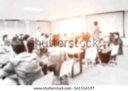 Blurred picture of student during study or exams in classroom in university. teacher kids learning abstract college school blurred testing professor training people lecture meeting group background