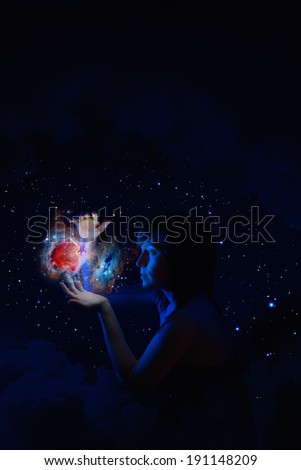 Girl holds the universe in her hands. Elements of this image furnished by NASA