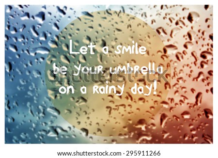 Inspirational quote with words Let a smile be your umbrella on blurred natural background with water drops on window glass texture