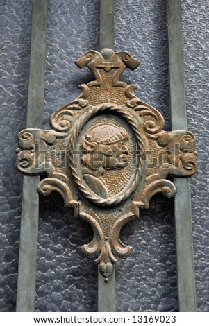 old shield door with the head of a roman soldier