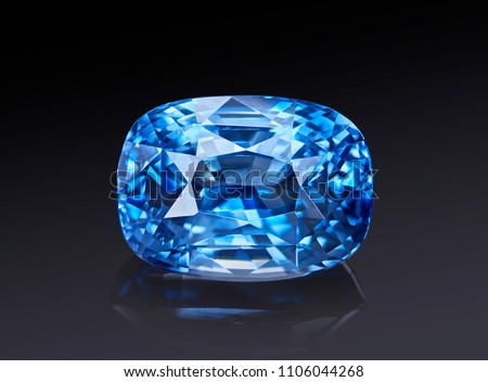 Luxury blue transparent sparkling gemstone  shape cushion cut sapphire isolated on black background.