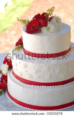 stock photo Wedding cake with red stripes and flowers