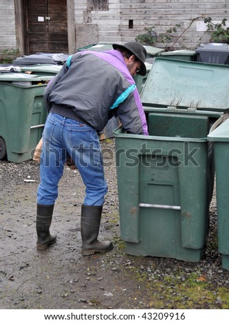 Man carefully placing glass bottle in recycle bin. This can also be used for a trash bin concept