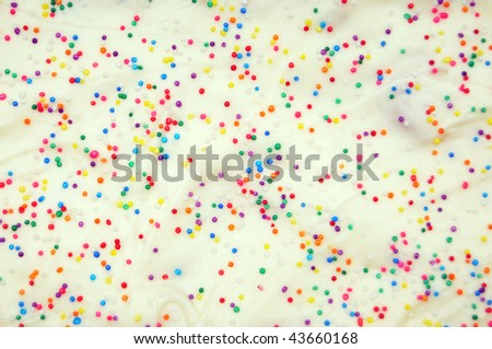 Multi-colored White Cake Pastry Sprinkles Texture Background closeup.