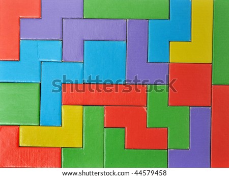 Abstract Colorful puzzle pieces put together. this makes a good  background. This toy is made out of cardboard and this image is a photograph.