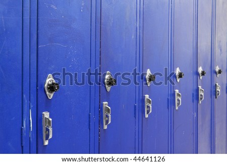 Ascending Blue High School Lockers with a spin dial for the combination code.