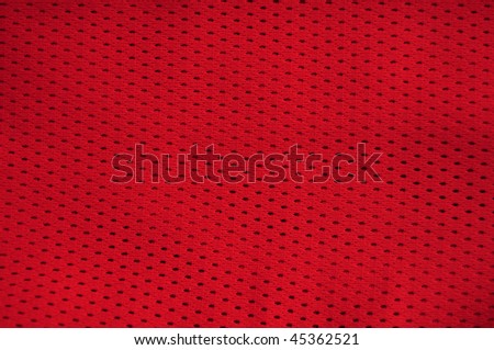 Close up of red polyester nylon red basketball sportswear shorts to created a textured background.