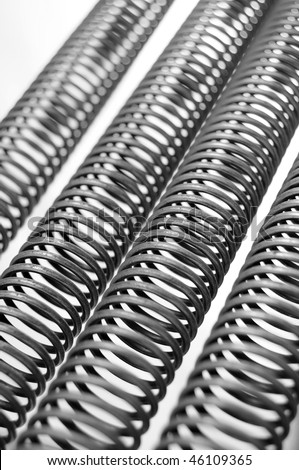 Four stretched out metal coils isolated on white background. The springs are stretched out.