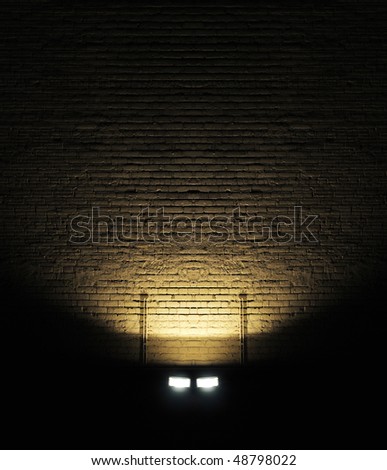 Old rough brick wall background texture with a spotlight shining on it