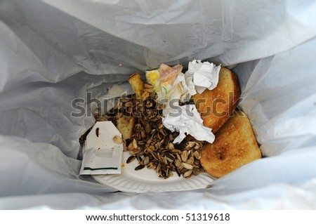 Leftover food and trash in a garbage bin