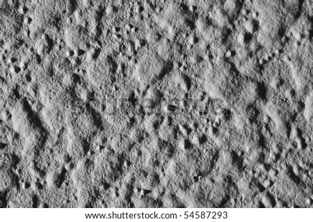 This is a closeup macro shot of a wall with harsh side lighting to make it look like the surface texture of the moon.