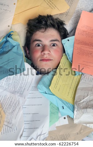 Young male student is overwhelmed by way too many homework assignments.