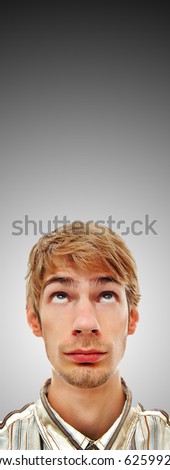 A young adult white Caucasian teenage man looking directly above. Professionally retouched. This is perfect for a vertical internet banner ad.
