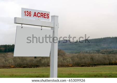 136 acres of land for sale with a blank wooden sign