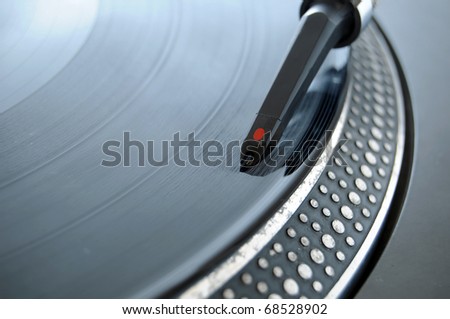DJ record needle on a 12 inch vinyl LP playing hiphop techno rave beats.