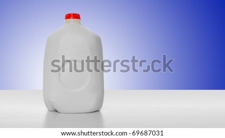 1 Gallon of Milk in a milk carton on a shiny table with blue background background.