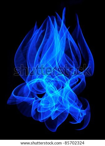 An abstract blue flame long exposure background isolated over a black background.
