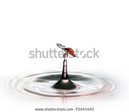 red water drop collision with another one sprouting from the water isolated on white abstract background
