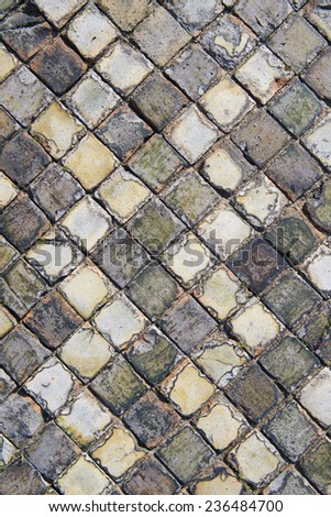 Very old and aged square tiles on the floor