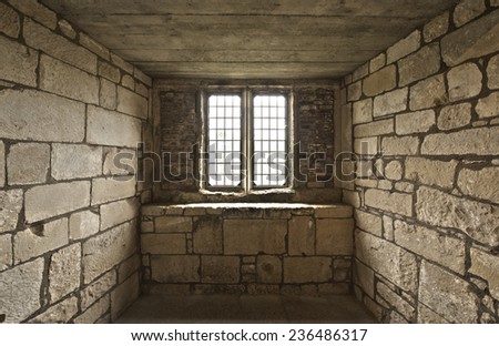 Old rustic looking midieval window cell with bricks