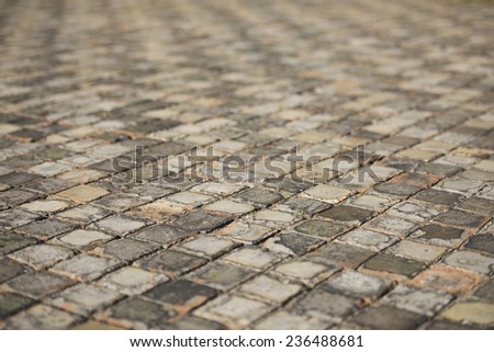 Very old and aged square tiles on the floor