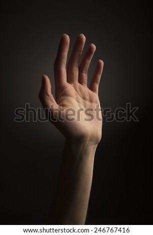 Skinny ectomorph hand reading up on black background